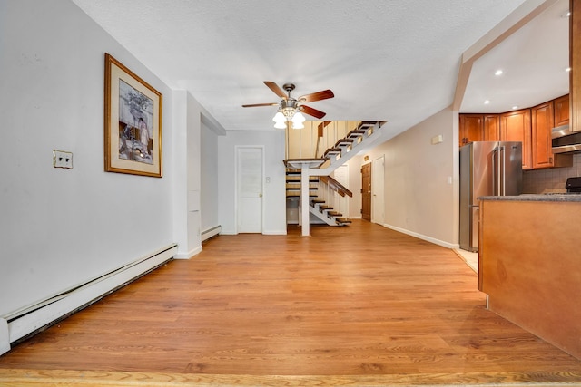 504 Julius Rd Unit 7C, College Point, NY 11356 - unfurnished living room featuring baseboard heating, a ceiling fan, light wood finished floors, recessed lighting, and a textured ceiling