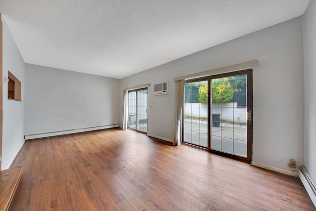 504 Julius Rd Unit 7C, College Point, NY 11356 - unfurnished room featuring a baseboard heating unit, baseboard heating, a wall unit AC, wood finished floors, and a textured ceiling