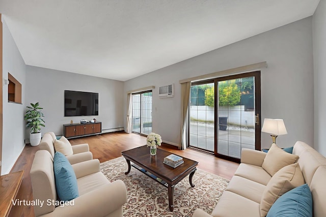 504 Julius Rd Unit 7C, College Point, NY 11356 - living room with a wall mounted air conditioner, light wood-style flooring, and a baseboard heating unit