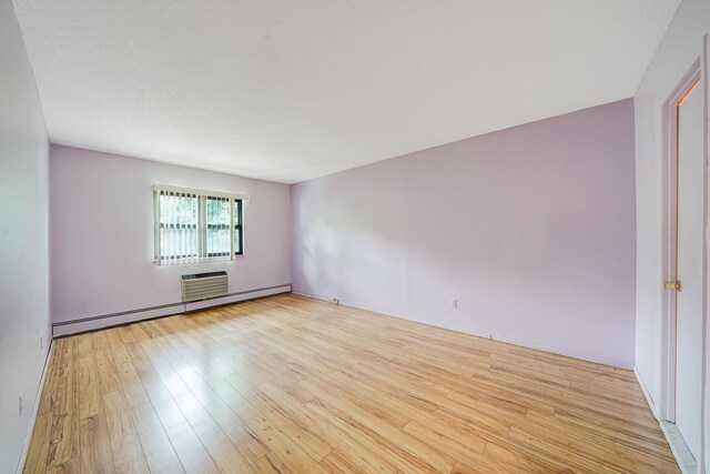 504 Julius Rd Unit 7C, College Point, NY 11356 - unfurnished room featuring baseboard heating and light wood-type flooring