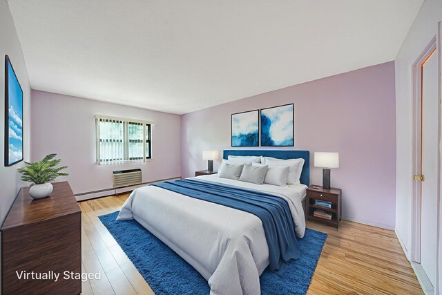 504 Julius Rd Unit 7C, College Point, NY 11356 - bedroom featuring light wood-style floors and a baseboard heating unit