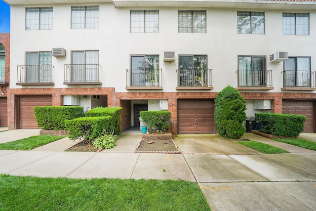504 Julius Rd Unit 7C, College Point, NY 11356 - view of property featuring a garage, driveway, and stucco siding