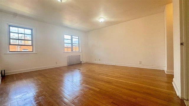 14133 78th Ave Unit 3B, Kew Garden Hills, NY 11367 - empty room featuring radiator and wood finished floors