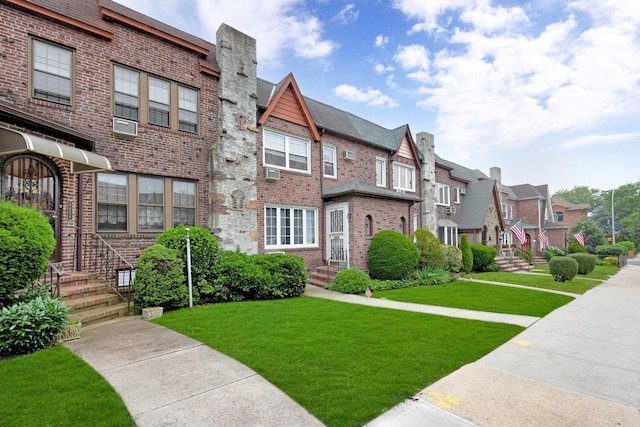 64-66 82nd Pl, Middle Village, NY 11379 - view of front of property featuring a residential view, brick siding, and a front yard