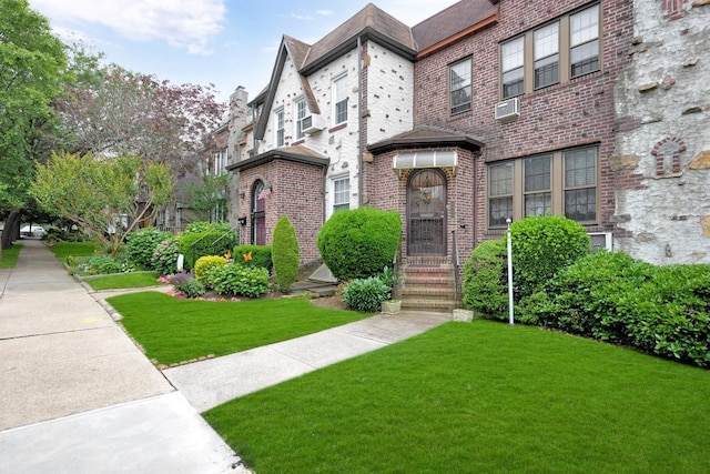 64-66 82nd Pl, Middle Village, NY 11379 - view of front of house with a front yard and brick siding