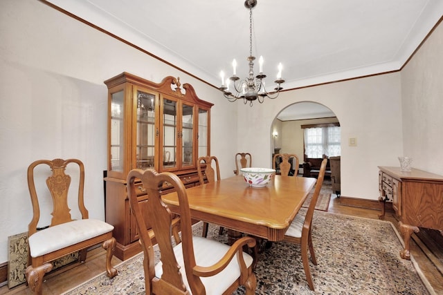 64-66 82nd Pl, Middle Village, NY 11379 - dining room featuring arched walkways, a chandelier, wood finished floors, and crown molding