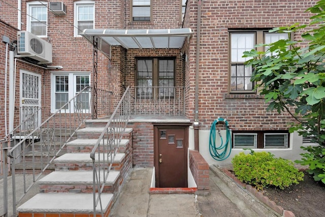 64-66 82nd Pl, Middle Village, NY 11379 - entrance to property with brick siding and a wall mounted air conditioner