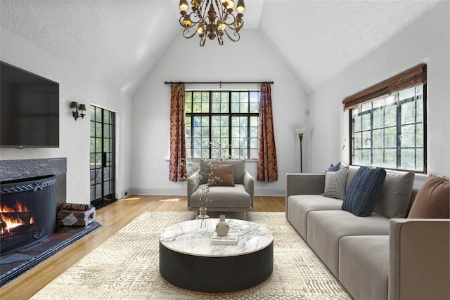1 Highwood Way, Larchmont, NY 10538 - living area featuring a chandelier, vaulted ceiling, a fireplace, and wood finished floors