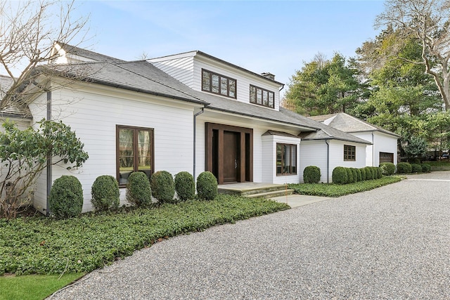178 Skimhampton Rd, Amagansett, NY 11937 - view of front facade featuring a garage and a chimney