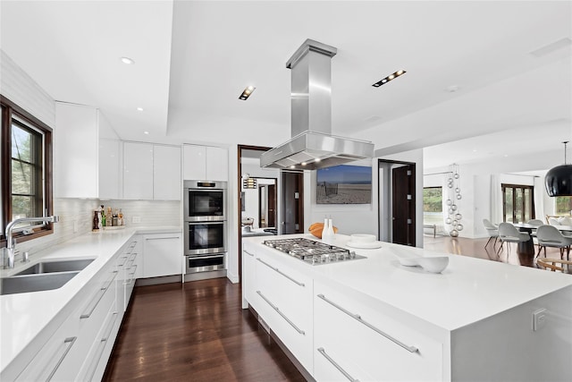 178 Skimhampton Rd, Amagansett, NY 11937 - kitchen featuring stainless steel appliances, island range hood, modern cabinets, decorative backsplash, and a center island