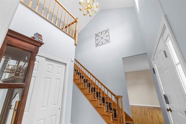 9 June Rd, Chester, NY 10918 - staircase with a high ceiling, wood finished floors, and a chandelier