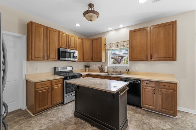 9 June Rd, Chester, NY 10918 - kitchen featuring stainless steel appliances, light countertops, brown cabinetry, a kitchen island, and recessed lighting