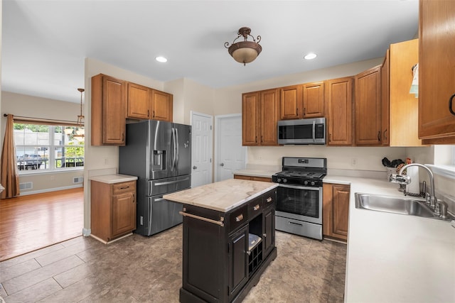 9 June Rd, Chester, NY 10918 - kitchen with stainless steel appliances, light countertops, recessed lighting, brown cabinets, and a center island