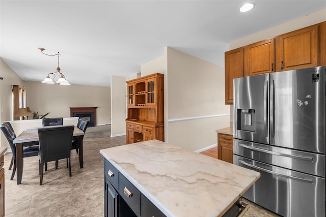 9 June Rd, Chester, NY 10918 - kitchen featuring stainless steel fridge, a fireplace, open floor plan, brown cabinetry, and recessed lighting