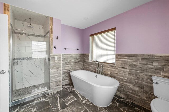 9 June Rd, Chester, NY 10918 - bathroom with tile walls, a wainscoted wall, a soaking tub, a marble finish shower, and marble tiled floors