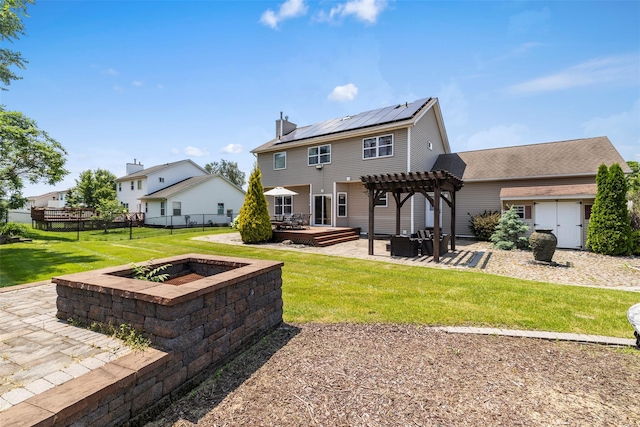 9 June Rd, Chester, NY 10918 - rear view of house featuring a patio, a pergola, a fire pit, roof mounted solar panels, and a deck