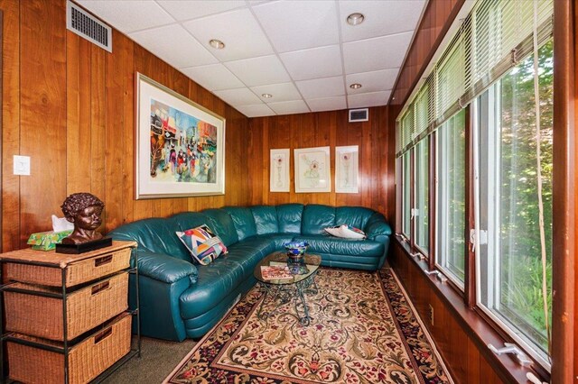 34 Elm St, Great Neck, NY 11021 - living room with plenty of natural light, wood walls, a drop ceiling, and carpet floors