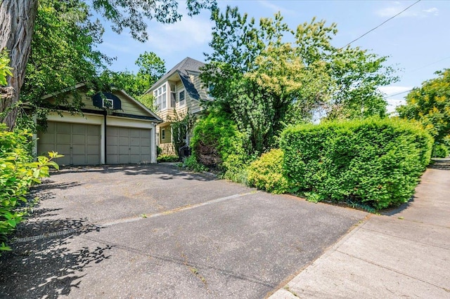 34 Elm St, Great Neck, NY 11021 - view of front of property featuring a detached garage and an outdoor structure