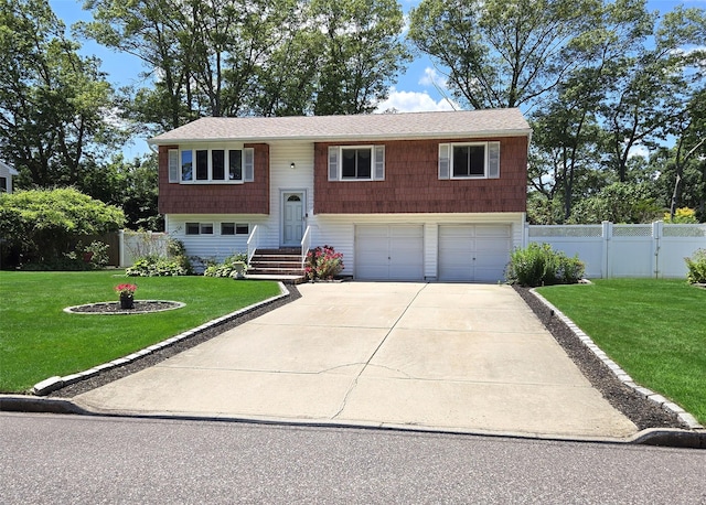 242 Wyandanch Rd, Sayville, NY 11782 - split foyer home featuring an attached garage and concrete driveway