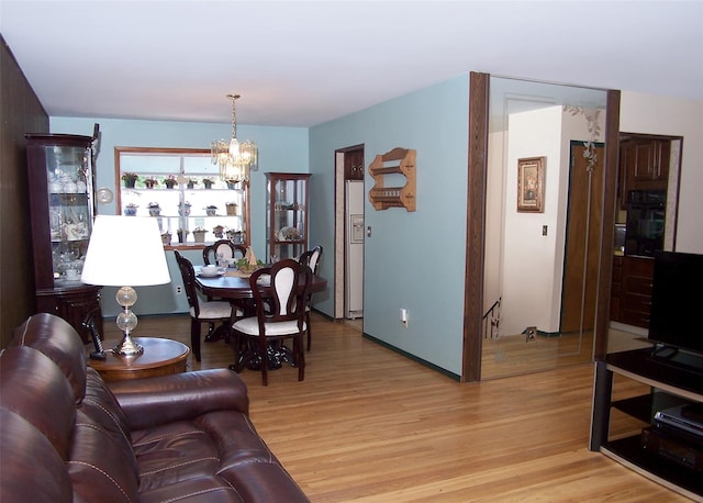 242 Wyandanch Rd, Sayville, NY 11782 - living area with a chandelier and light wood-style flooring