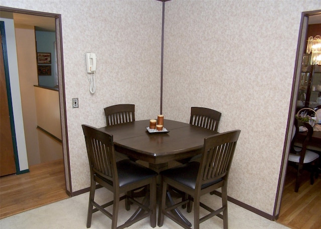 242 Wyandanch Rd, Sayville, NY 11782 - dining area with wallpapered walls and light wood-type flooring