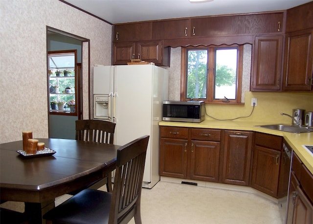 242 Wyandanch Rd, Sayville, NY 11782 - kitchen with stainless steel microwave, white refrigerator with ice dispenser, light countertops, dishwasher, and wallpapered walls