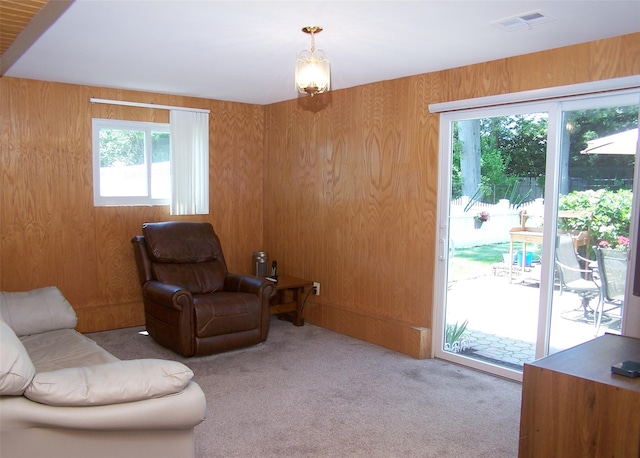 242 Wyandanch Rd, Sayville, NY 11782 - living room featuring carpet flooring and wood walls