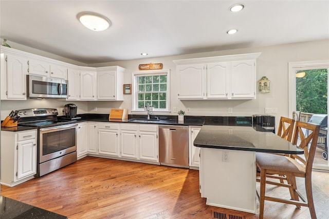 10 Jennifer Ln, Carmel, NY 10512 - kitchen featuring appliances with stainless steel finishes, a peninsula, a kitchen bar, healthy amount of natural light, and recessed lighting