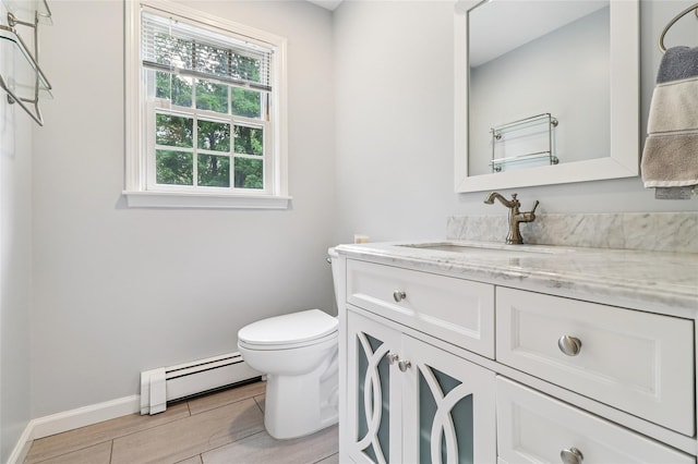 10 Jennifer Ln, Carmel, NY 10512 - bathroom featuring a baseboard heating unit, vanity, and wood finished floors