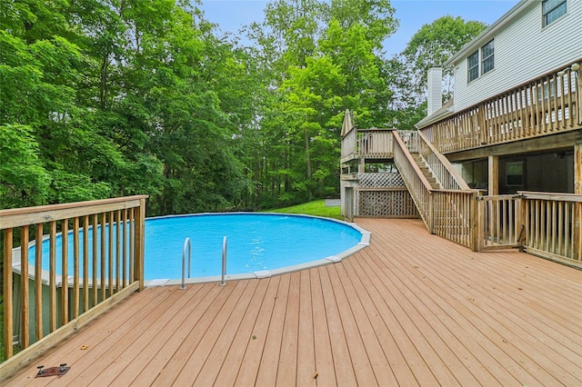 10 Jennifer Ln, Carmel, NY 10512 - outdoor pool featuring a wooden deck, stairway, and view of scattered trees