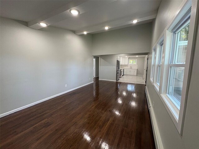 9 Holt St, Amityville, NY 11701 - spare room featuring dark wood-style flooring, plenty of natural light, and recessed lighting