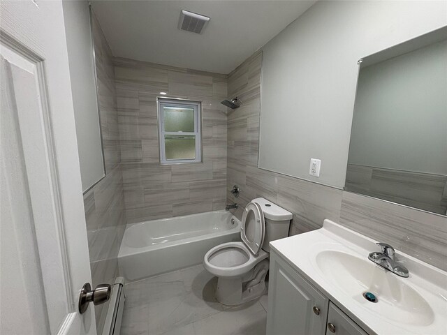 9 Holt St, Amityville, NY 11701 - full bathroom with baseboard heating, vanity, tile walls, bathing tub / shower combination, and marble finish flooring