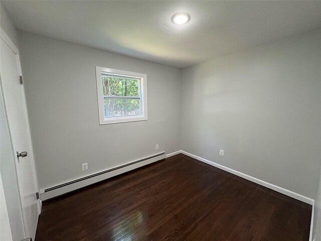9 Holt St, Amityville, NY 11701 - unfurnished room featuring a baseboard radiator and dark wood-type flooring