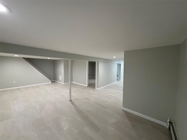 9 Holt St, Amityville, NY 11701 - finished below grade area featuring recessed lighting and a baseboard radiator