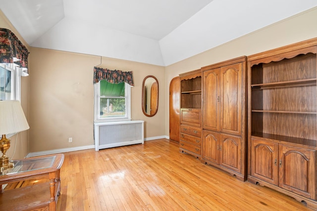 46-27 195th St, Flushing, NY 11358 - unfurnished living room featuring radiator, lofted ceiling, and light wood-style floors