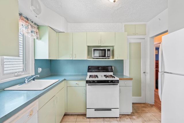 46-27 195th St, Flushing, NY 11358 - kitchen featuring white appliances, cream cabinetry, a textured ceiling, and light tile patterned floors