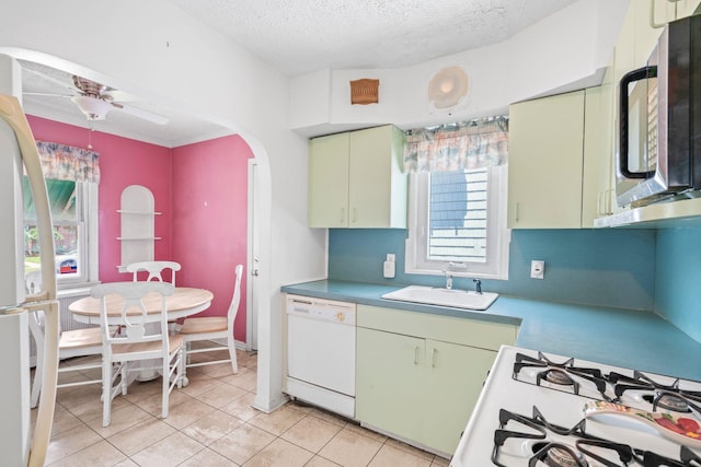 46-27 195th St, Flushing, NY 11358 - kitchen featuring white appliances, a textured ceiling, light tile patterned floors, ceiling fan, and arched walkways