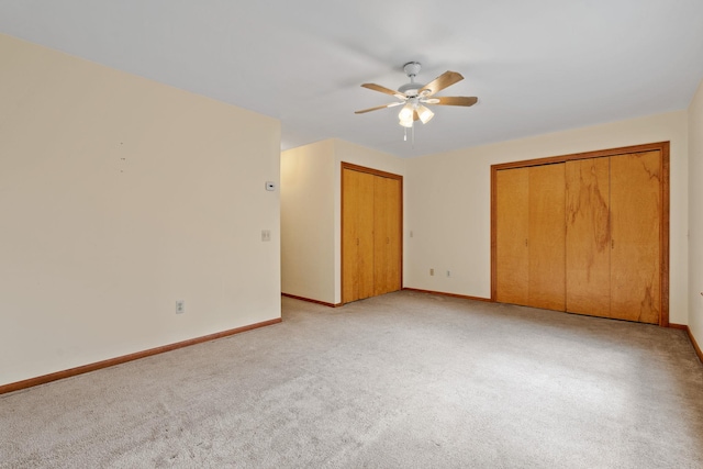 41-59 Fox Mountain Rd, Livingston Manor, NY 12758 - unfurnished bedroom with light colored carpet, two closets, and a ceiling fan