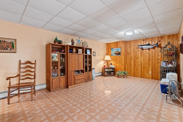 41-59 Fox Mountain Rd, Livingston Manor, NY 12758 - living area featuring a paneled ceiling, wooden walls, light flooring, and baseboard heating