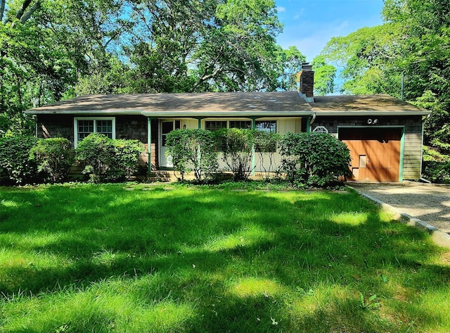 49 Sayres Path, Wainscott, NY 11975 - ranch-style home featuring an attached garage, a chimney, driveway, and a front lawn