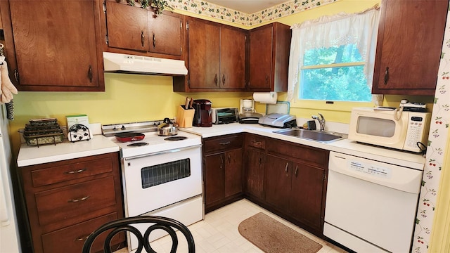 49 Sayres Path, Wainscott, NY 11975 - kitchen featuring white appliances, under cabinet range hood, light countertops, light floors, and dark brown cabinetry