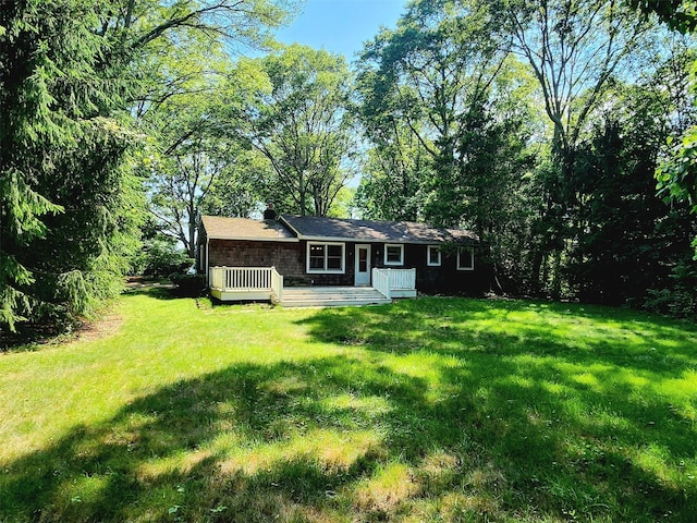 49 Sayres Path, Wainscott, NY 11975 - rear view of property featuring a wooden deck and a lawn