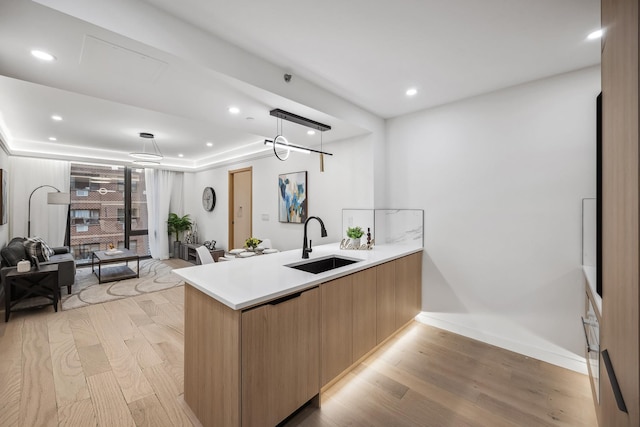 168 E 111th St Unit 8B, New York Manhattan, NY 10029 - kitchen with modern cabinets, light wood-type flooring, a peninsula, open floor plan, and recessed lighting