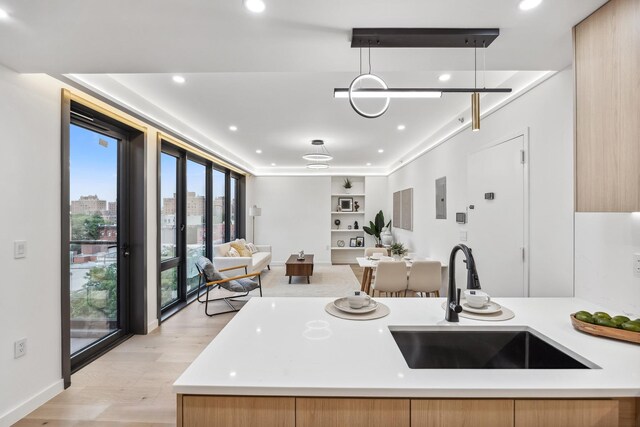 168 E 111th St Unit 8B, New York Manhattan, NY 10029 - kitchen featuring healthy amount of natural light, open floor plan, light countertops, built in shelves, and recessed lighting