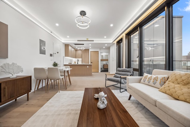 168 E 111th St Unit 8B, New York Manhattan, NY 10029 - living area featuring light wood finished floors, recessed lighting, and electric panel