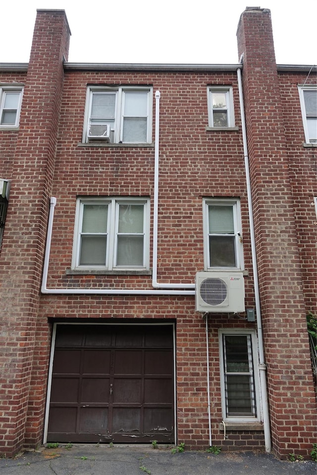 4120 Murdock Ave, Bronx, NY 10466 - view of front of property with brick siding, asphalt driveway, and an attached garage