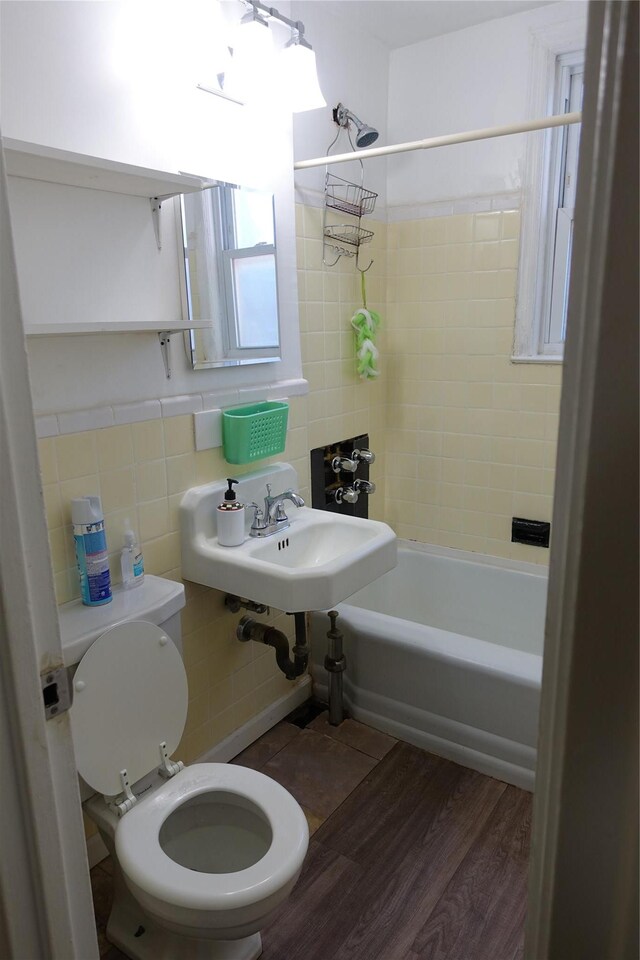 4120 Murdock Ave, Bronx, NY 10466 - bathroom with tile walls, shower / tub combination, and wood finished floors