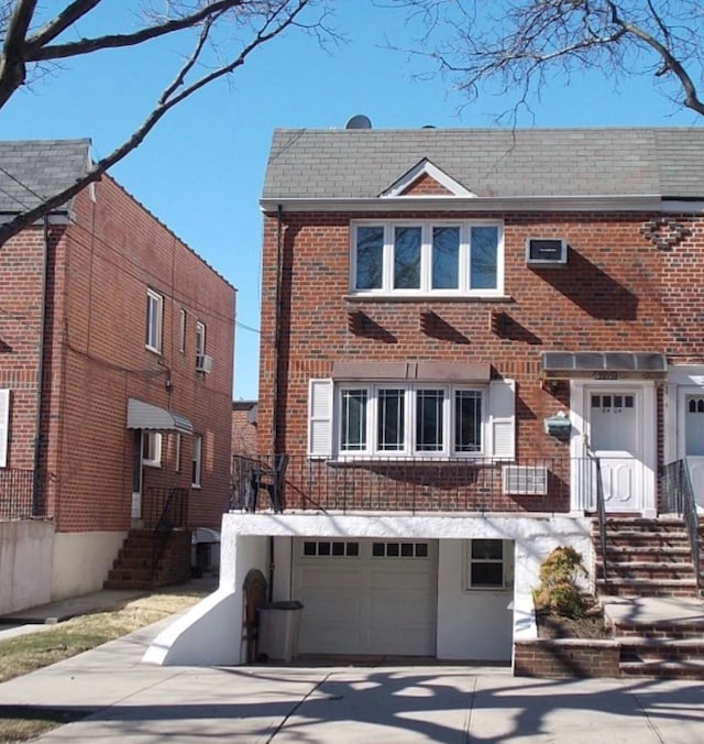 6404 78th St, Middle Village, NY 11379 - view of front facade with brick siding, an attached garage, and concrete driveway