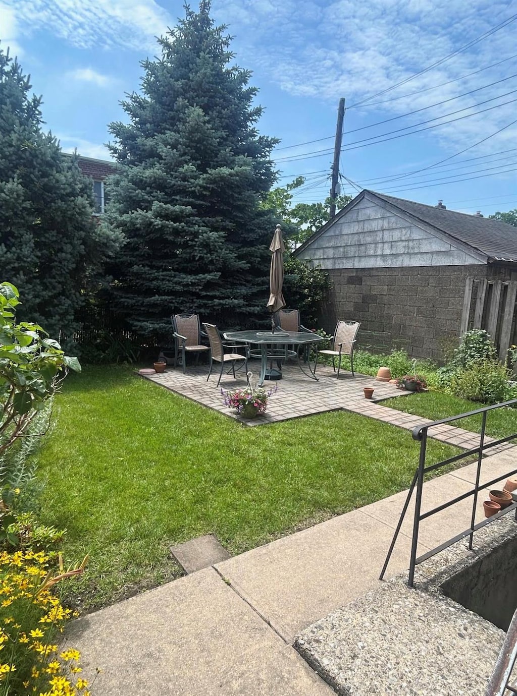 6404 78th St, Middle Village, NY 11379 - view of grassy yard with a patio