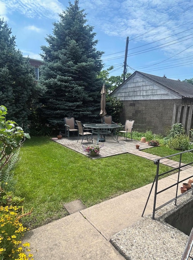 6404 78th St, Middle Village, NY 11379 - view of grassy yard with a patio